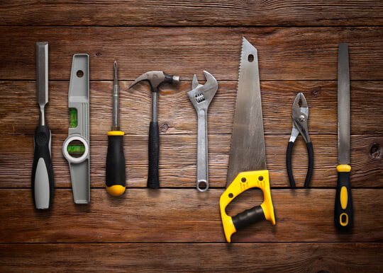 Prime Share Savings: Tools lined up on a wood background.