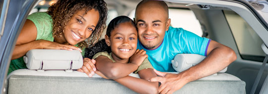 Young family looking our the back of their SUV