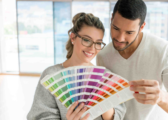 young homeowners looking at paint samples