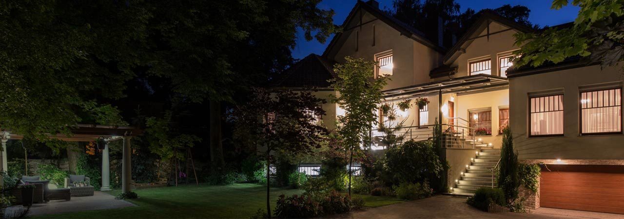 Home Loan Rates: Beautiful home exterior lit up at night.