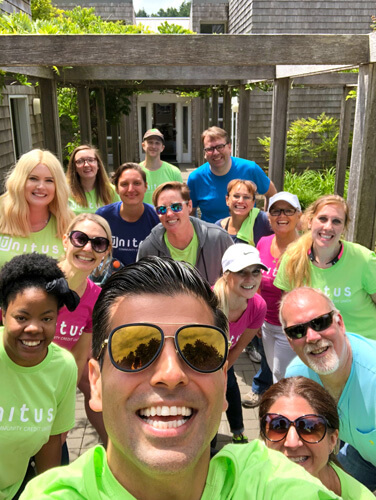 Unitus community involvement highlights, employees volunteering at children's cancer association caring cabin