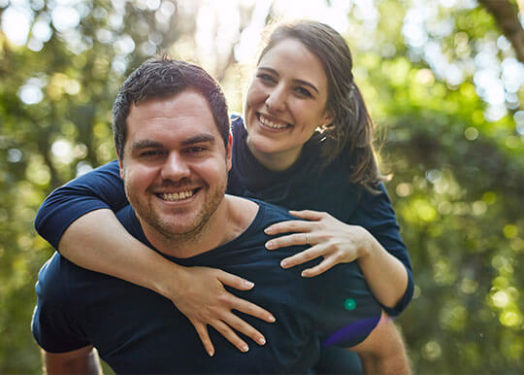 man giving piggyback ride to woman