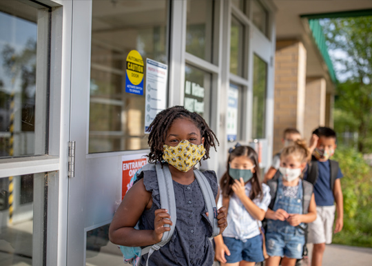 young children with masks at school