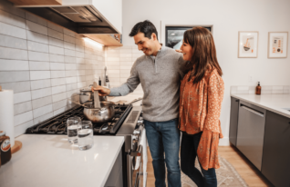 Gen X couple cooking dinner in new home