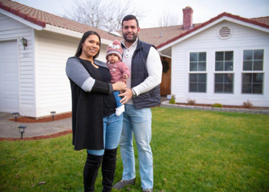 latino family in front of house
