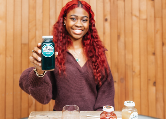 honey bee lemonade spokesperson holding product