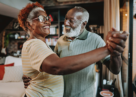 Older retired couple dancing