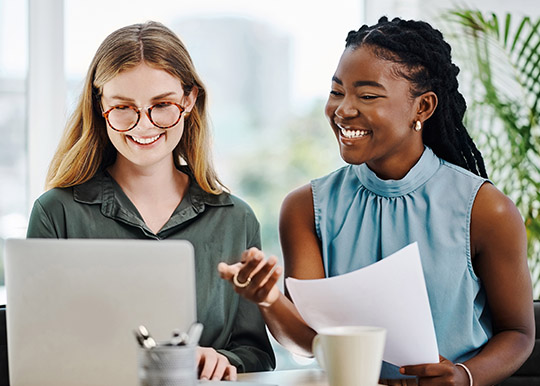 Two young women discussing investments